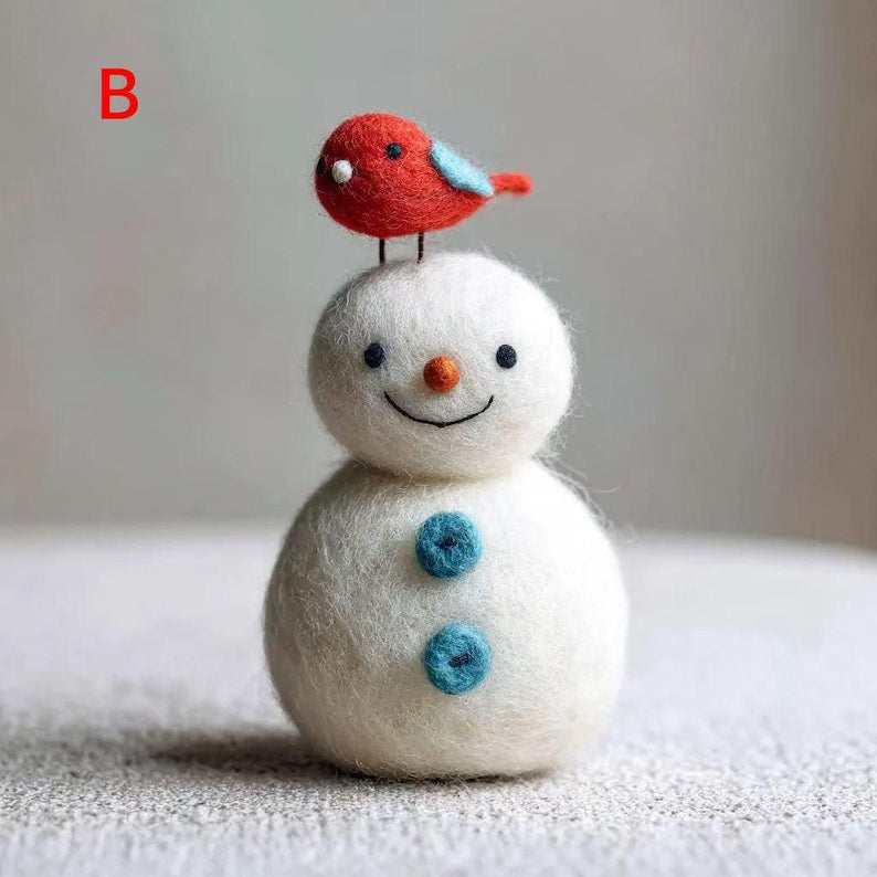 Handmade needle-felted wool snowman with a little bird, a whimsical winter decoration by ilovefelt