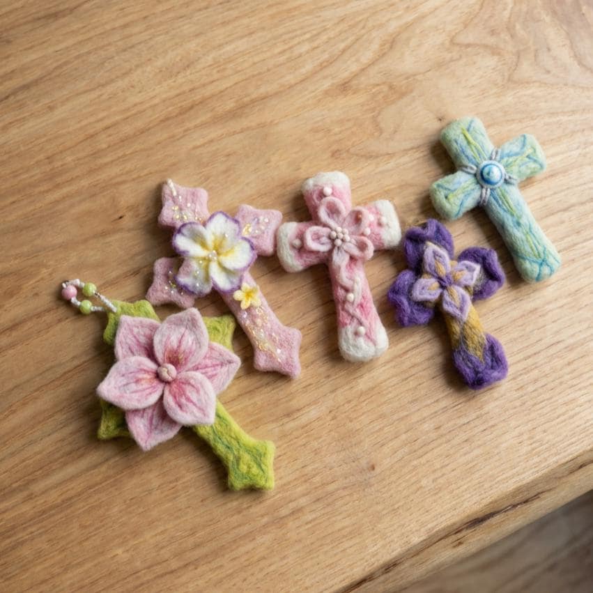 Hand felted wool floral cross pendant ¨C side angle showing handcrafted wool texture and details.