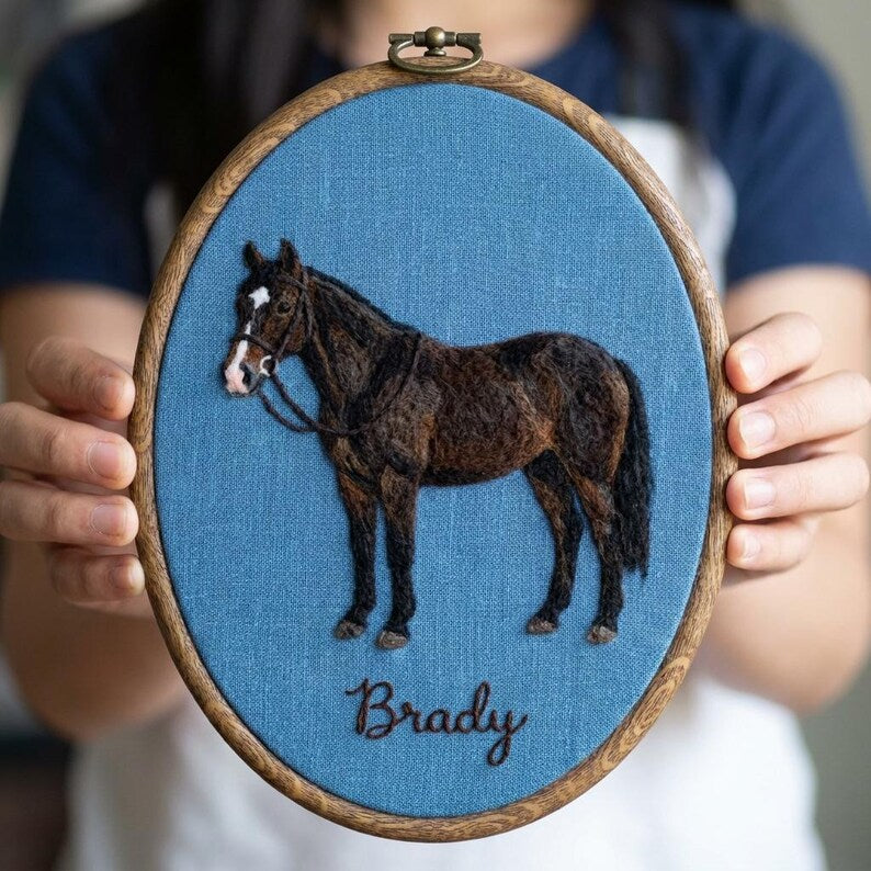 Horse portrait in an oval hoop on blue fabric